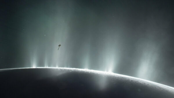 This artist's impression depicts NASA's Cassini spacecraft flying through a plume of presumed water erupting from the surface of Saturn's moon Enceladus.