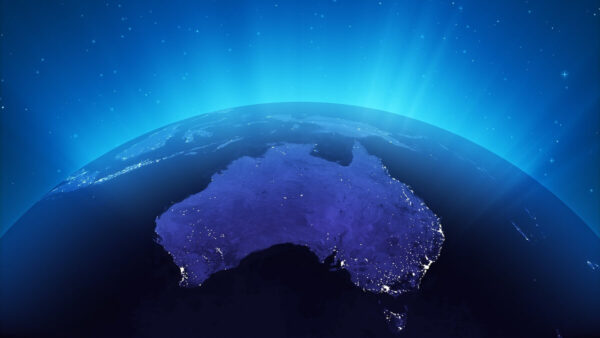 looking down on australia from space. There is a glow coming off the earth