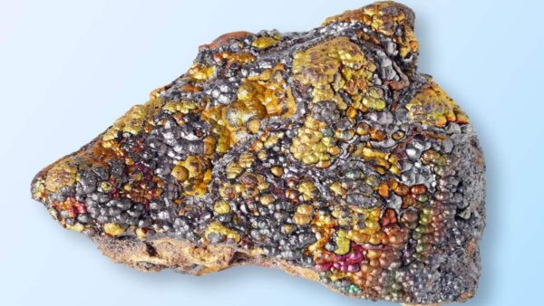 colourful, shiny mineral goethite against a blue background