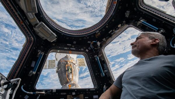 ISS 66 Astronaut Mark Vande Hei peers at the Earth below