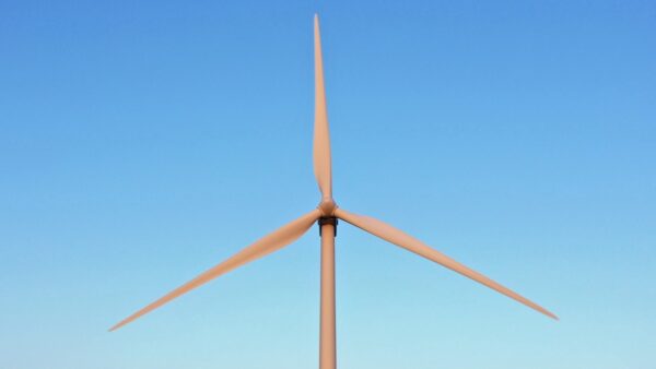 wind turbine blades against a blue sky