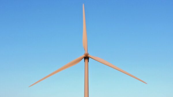 wind turbine blades against a blue sky