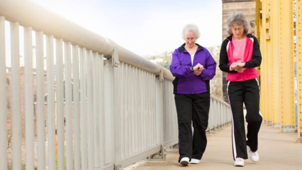 elderly women walking with smart watches on. algorithm