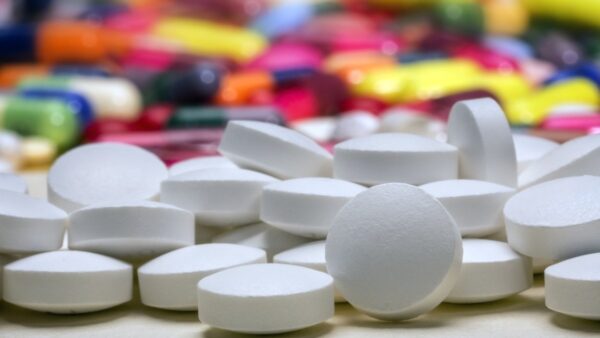 new antibiotic pills in front of old coloured antibiotics