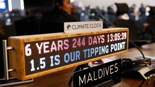 A digital sign at the Maldives seat at climate conference says: 6 years. 244 days. 13:05:39. 1.5 is our tipping point "Climate Clock"