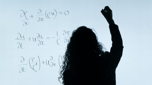 person writing maths on digital whiteboard