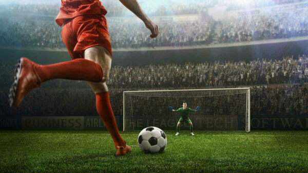 football-player-shoots-at-goal-keeper-crowd