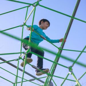 Child on balance-oriented playground equipment