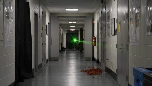 university hallway with green laser pointed down centre