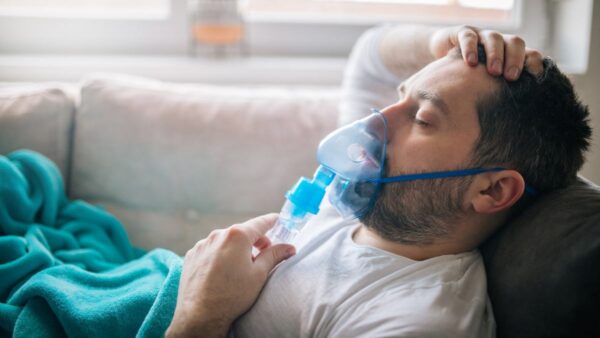 Man wearing an inhaler mask suffering from COPD
