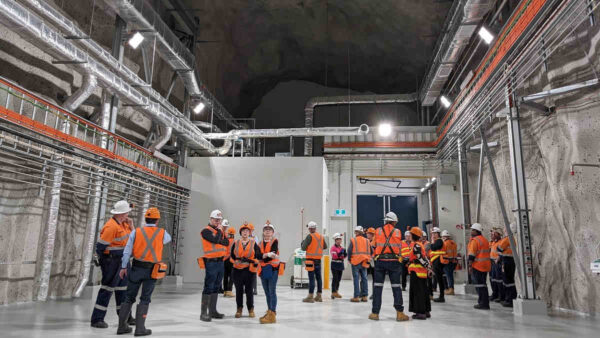 stawell-underground-physics-laboratory-launch-individuals-wearing-high-vis-orange-vests-in-mine