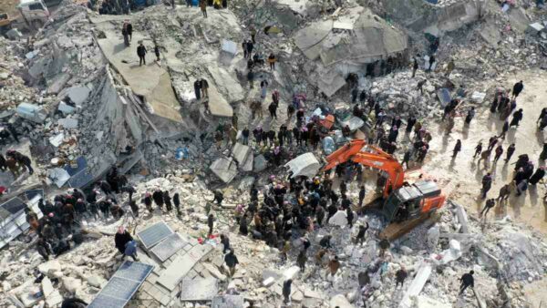 aerial view of people among earthquake rubble