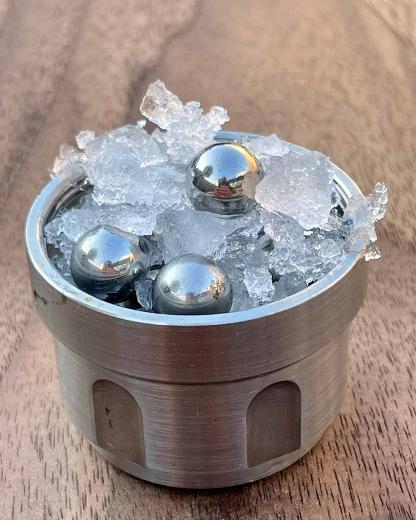 Normal ice, steel balls, inside a tumbler, part of the set up for creating amorphous ice