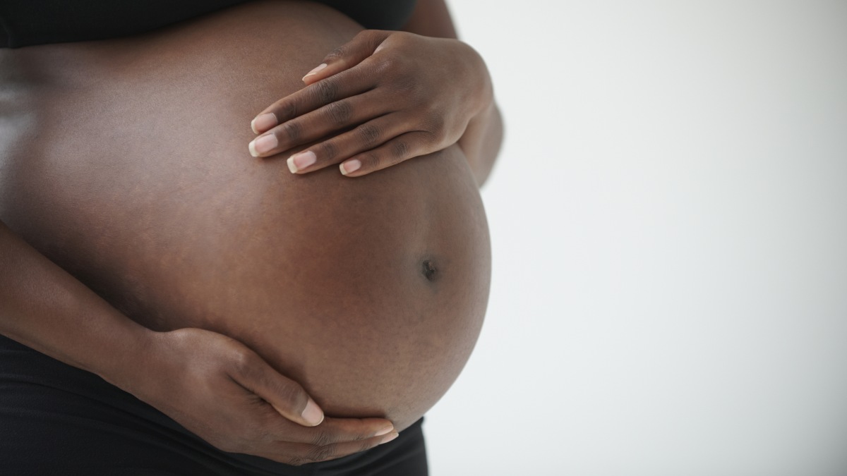 close up of pregnant person's stomach
